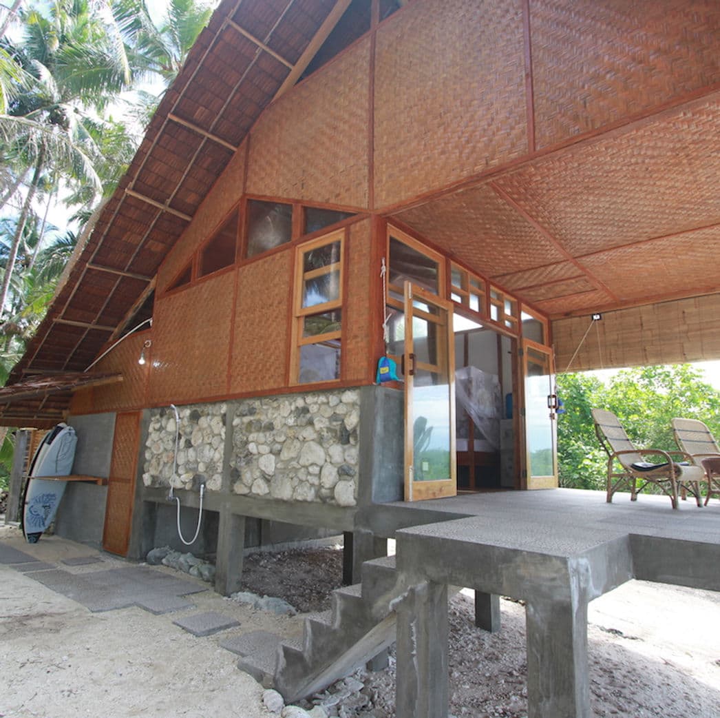 Private bungalow at Asu Camp beneath palms