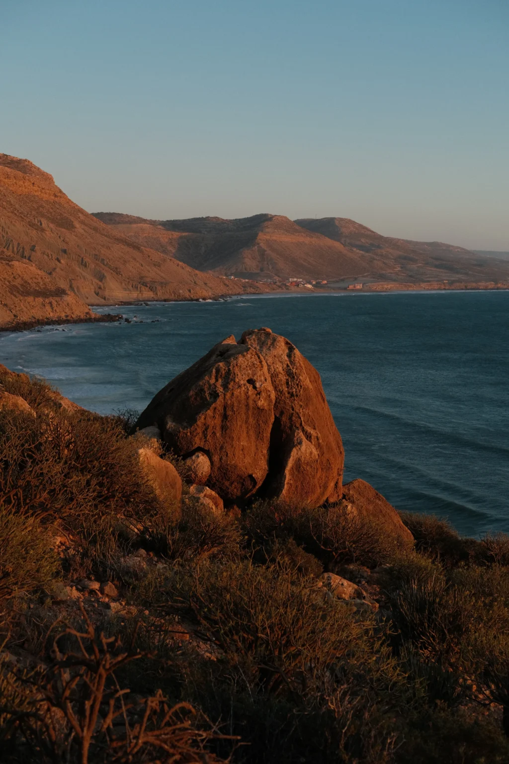 The coast north of Imsouane at last light, rock and headland above the Atlantic