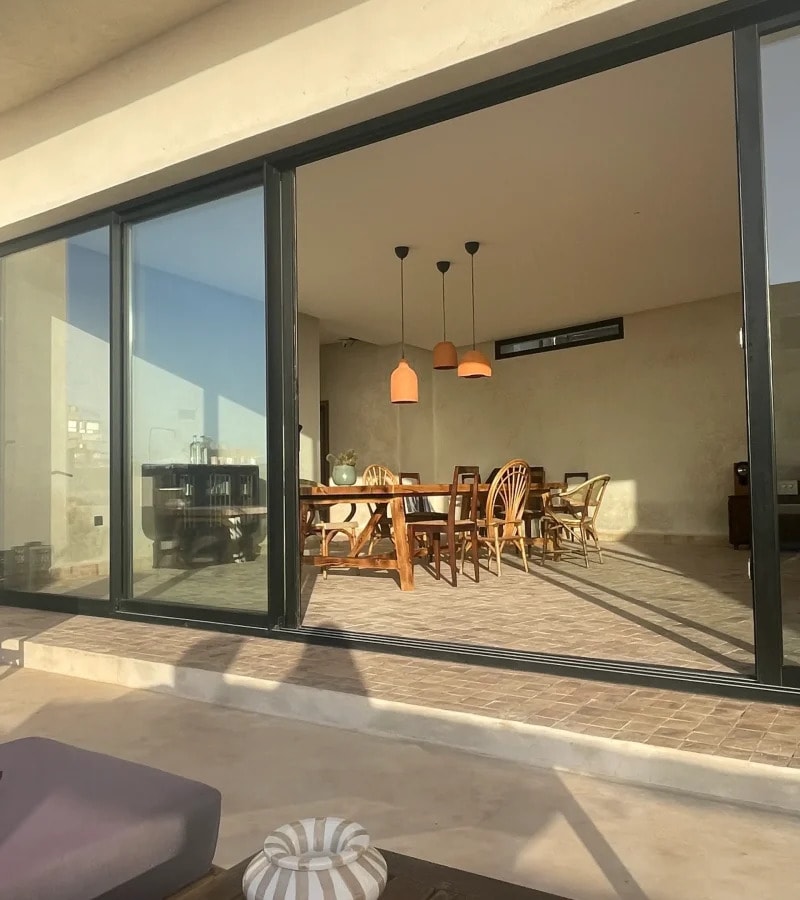 The dining room seen through the open glass doors from the terrace