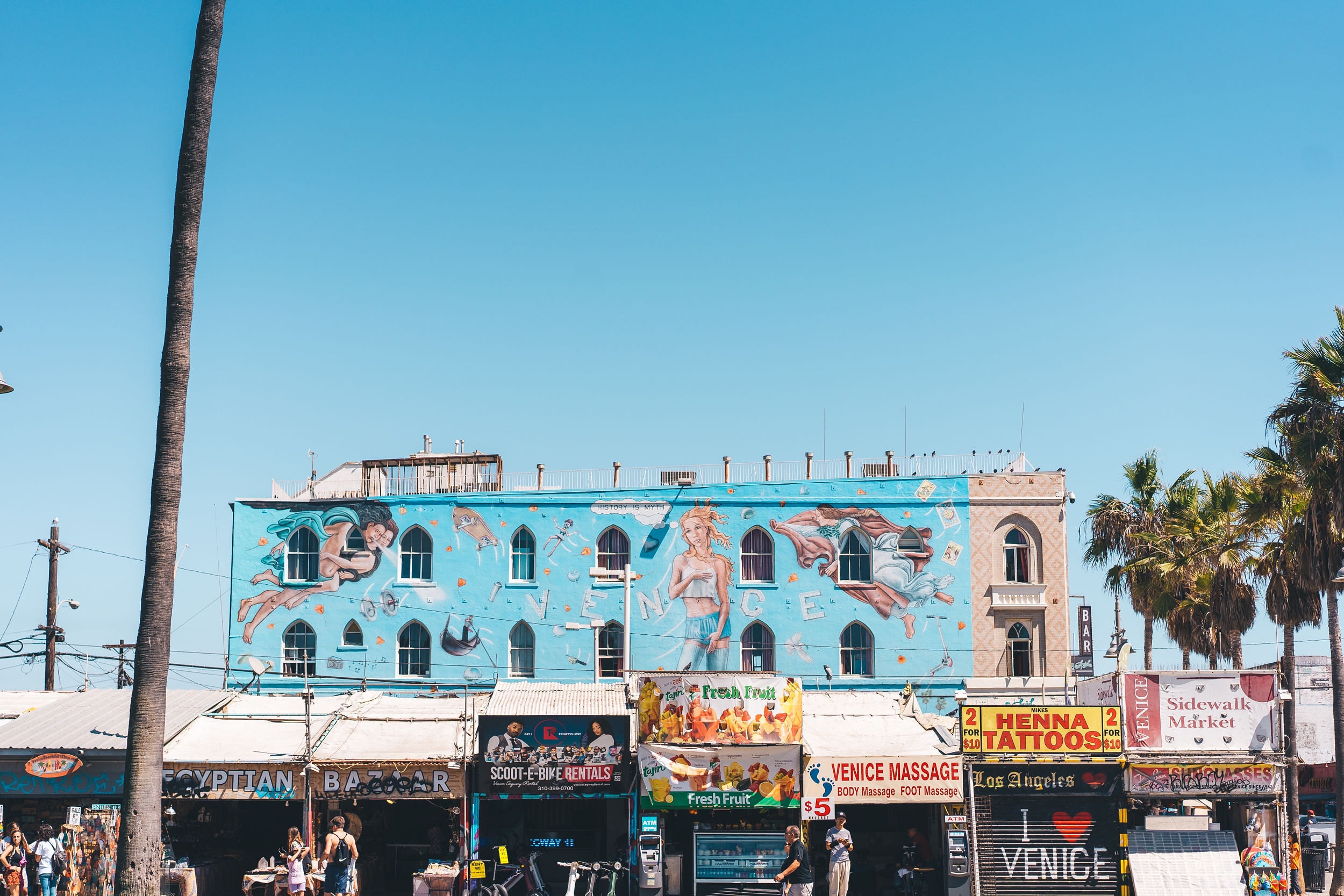 The painted building and palm trees on the Venice Beach boardwalk