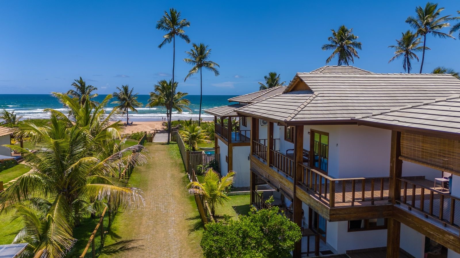 Caminho do Mar from above, with a lawn path running down to the beach