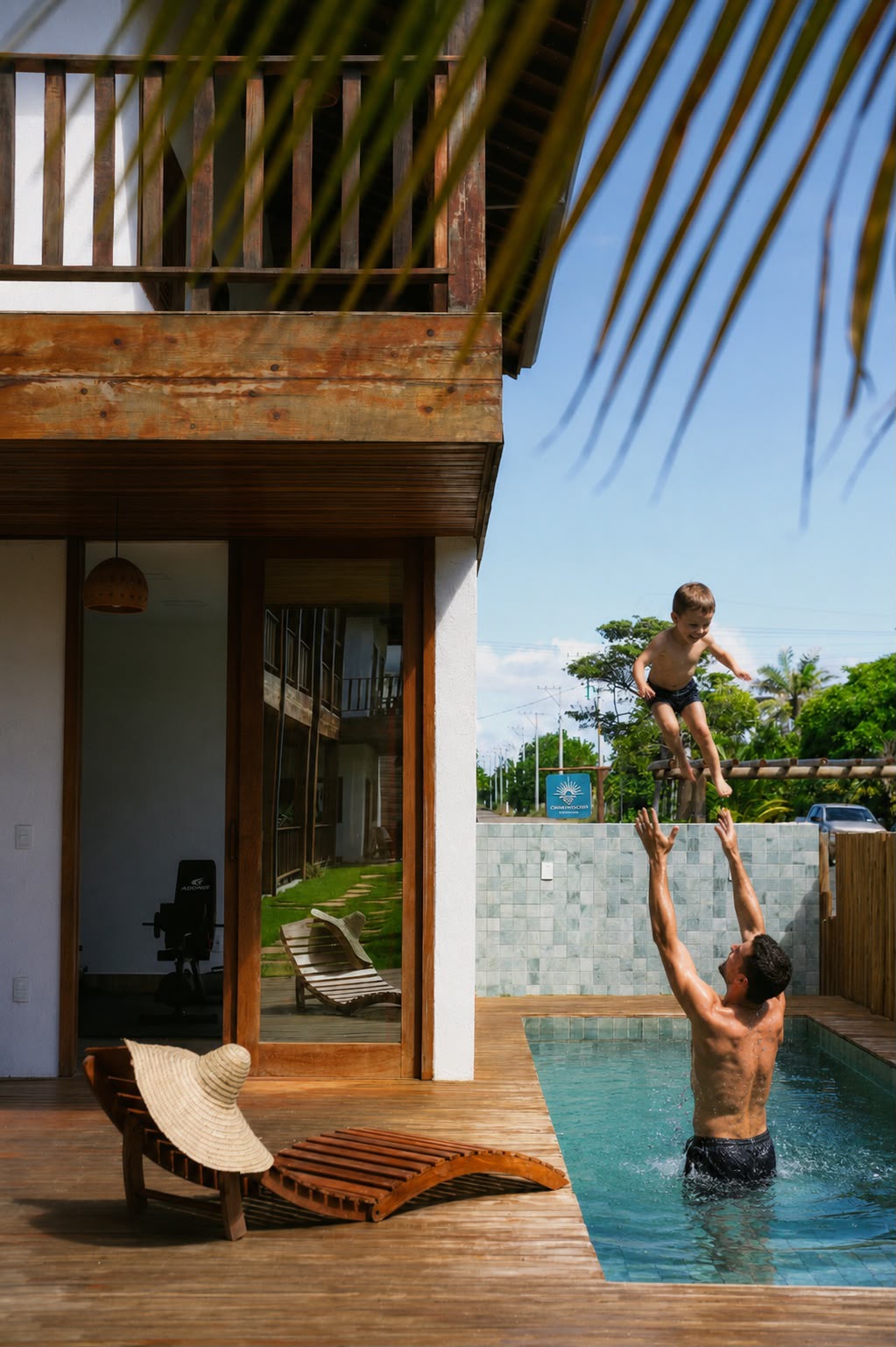 Father and son playing by the private plunge pool on the deck of a ground floor unit