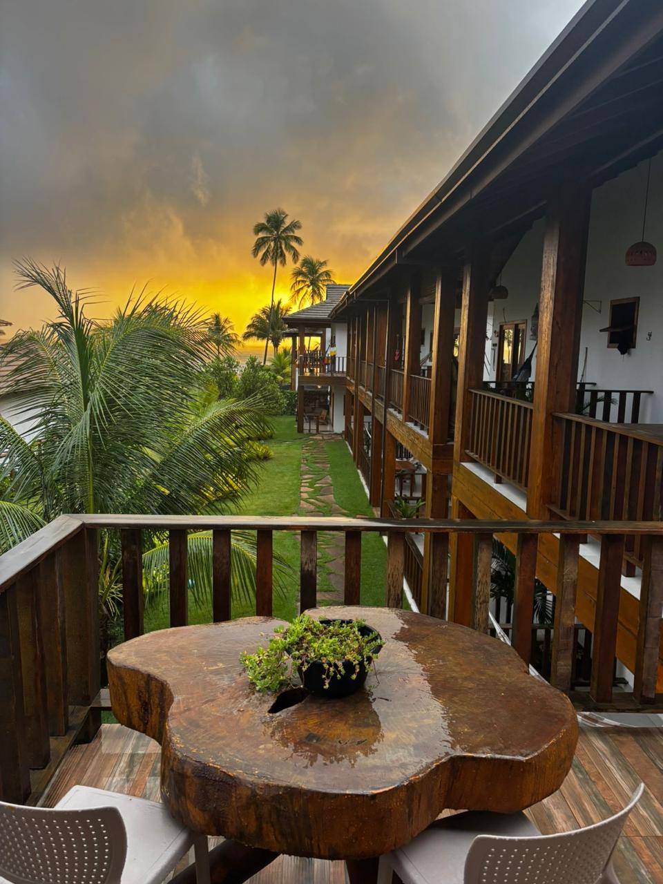 Sunset from an upper veranda looking down the lawn toward the ocean