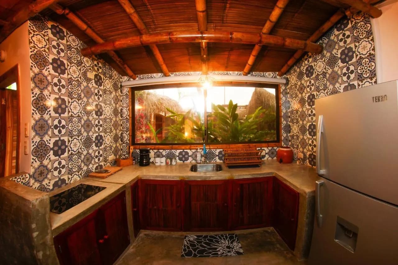 Tiled outdoor kitchen with fridge and stovetop
