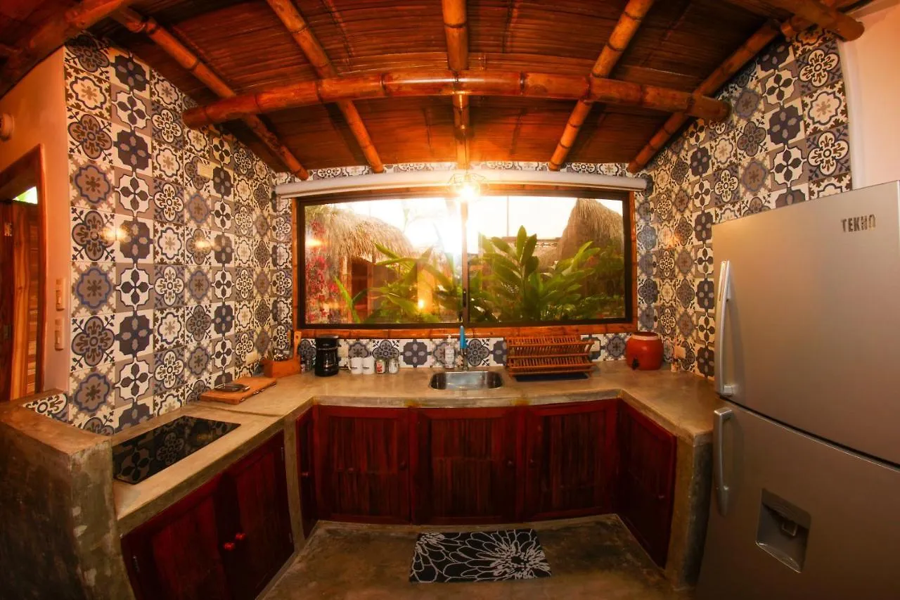 Tiled outdoor kitchen with fridge and stovetop