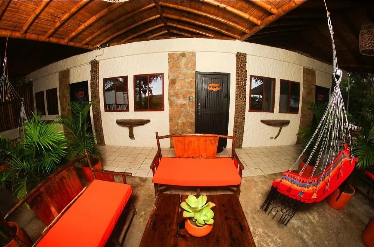 Garden lounge terrace with orange cushions and a hanging chair